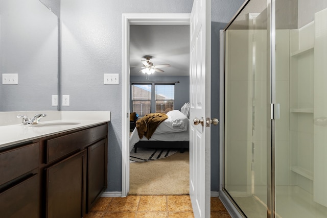 bathroom featuring walk in shower, vanity, and ceiling fan