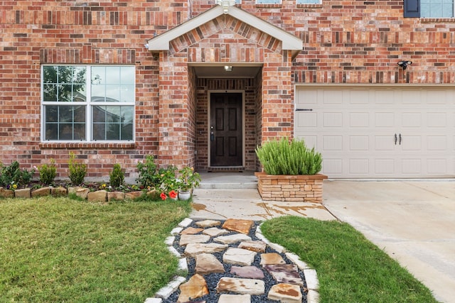 doorway to property featuring a garage and a yard