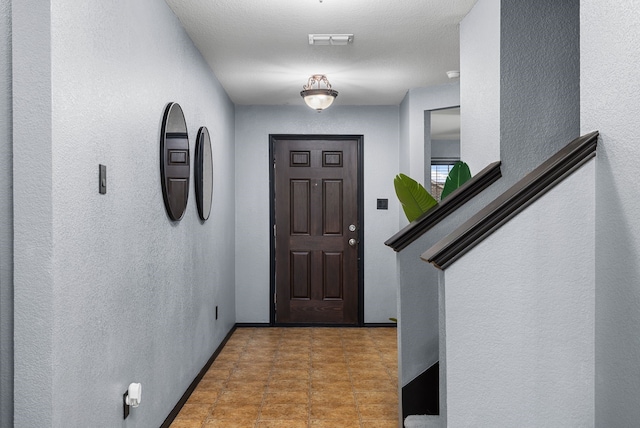 entryway featuring a textured ceiling