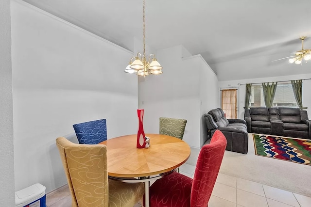 tiled dining space with ceiling fan with notable chandelier