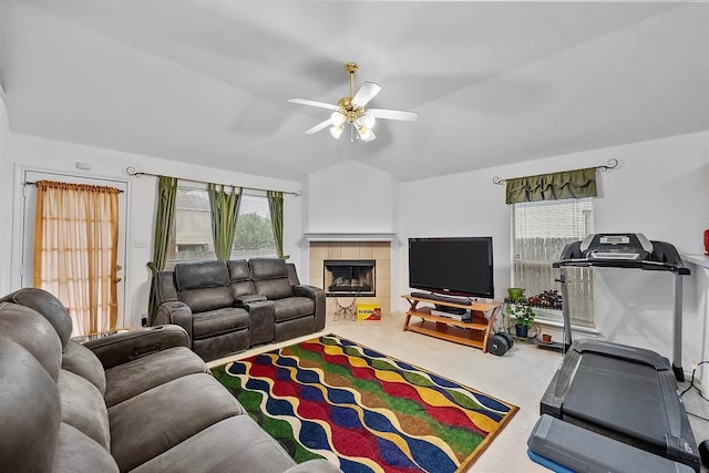 living room with a fireplace, ceiling fan, carpet flooring, and lofted ceiling