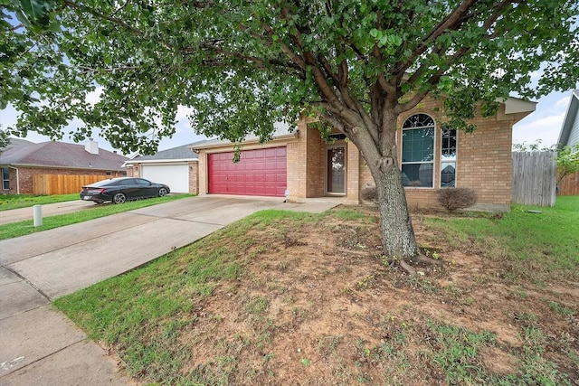 single story home featuring a garage and a front lawn