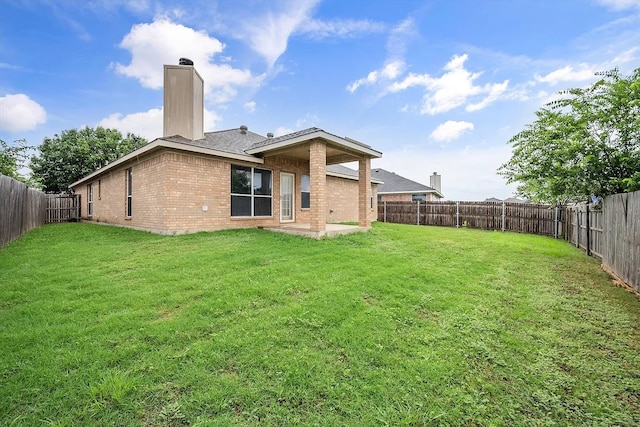 back of house featuring a lawn