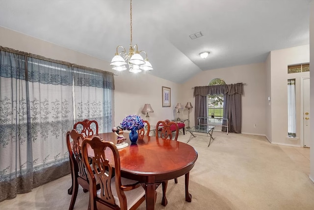 carpeted dining area featuring vaulted ceiling and a notable chandelier