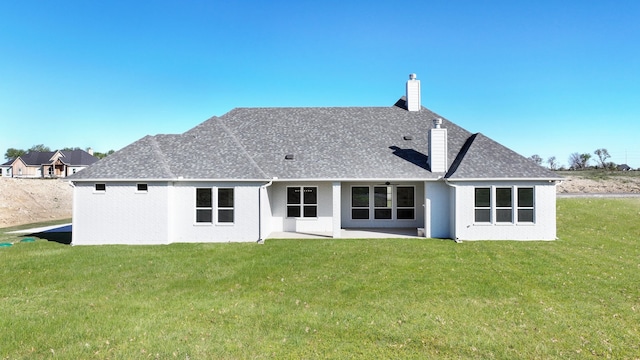 back of house with a yard and a patio