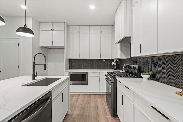 kitchen featuring white cabinetry, sink, and appliances with stainless steel finishes