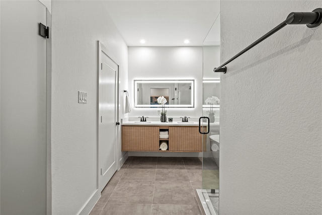 bathroom featuring vanity and an enclosed shower