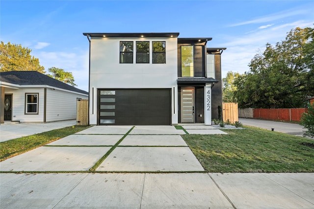 modern home with a garage and a front lawn