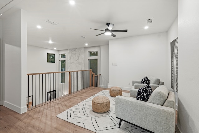 living room featuring light hardwood / wood-style floors and ceiling fan