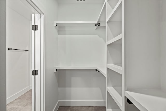 spacious closet with tile patterned floors