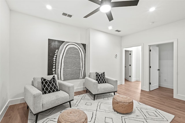 sitting room featuring light hardwood / wood-style floors and ceiling fan