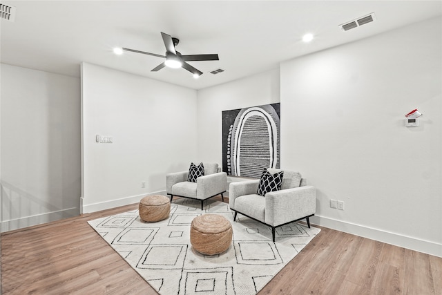 living area with light wood-type flooring and ceiling fan