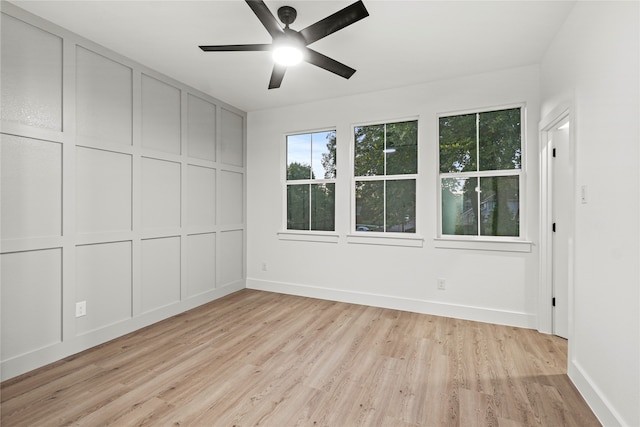 unfurnished room with light wood-type flooring and ceiling fan