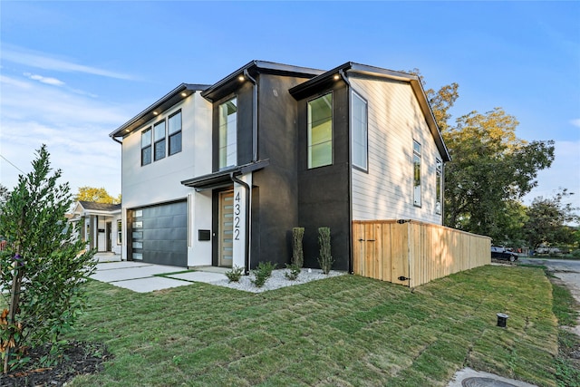 view of front of house with a garage and a front yard