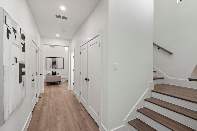 corridor with light hardwood / wood-style floors