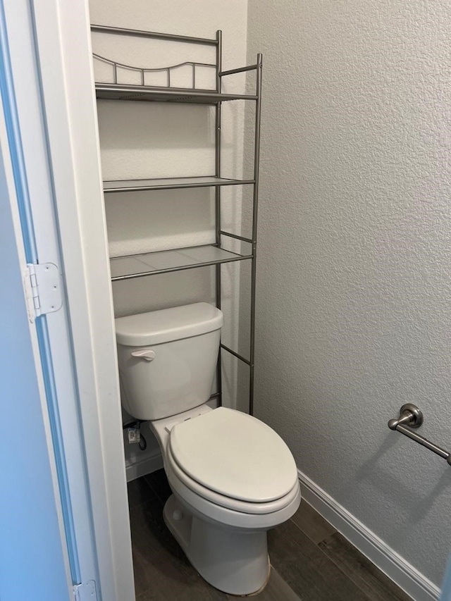 bathroom featuring hardwood / wood-style floors and toilet