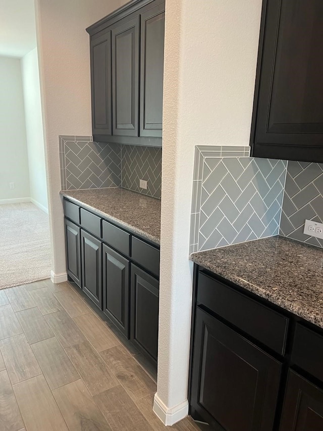 kitchen featuring dark stone countertops and backsplash