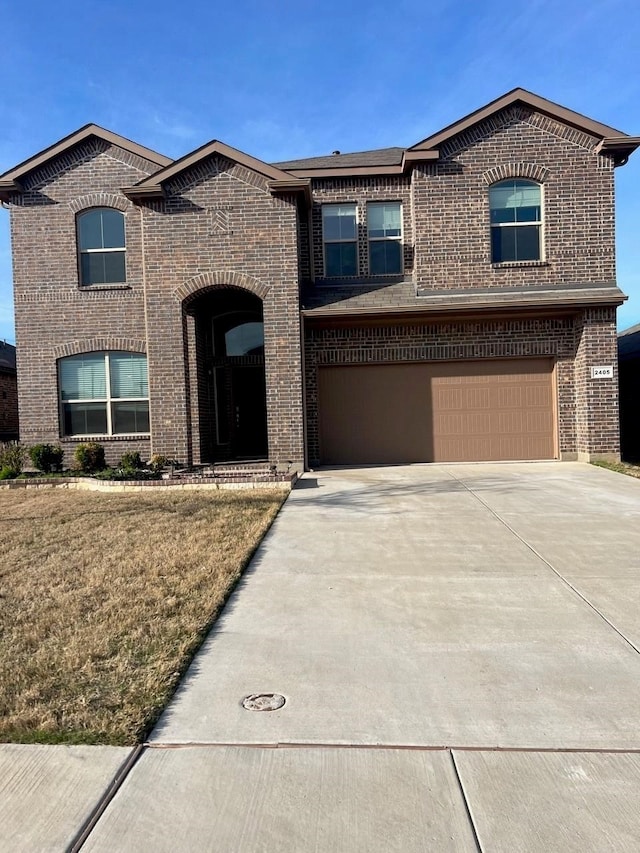 view of front of house with a garage and a front yard