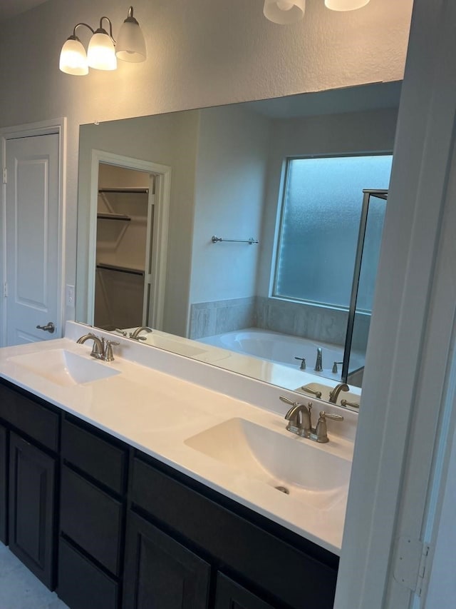 bathroom with vanity and a tub