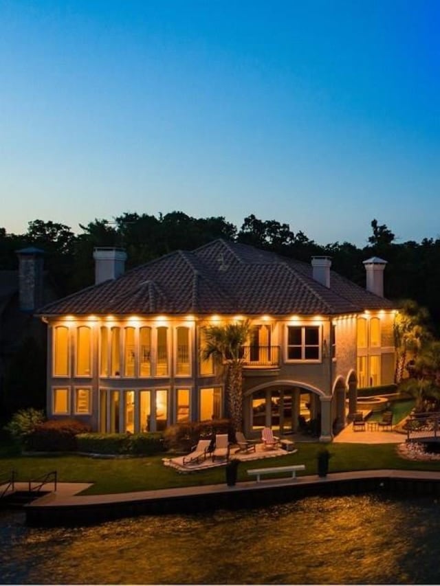 back house at dusk with a yard