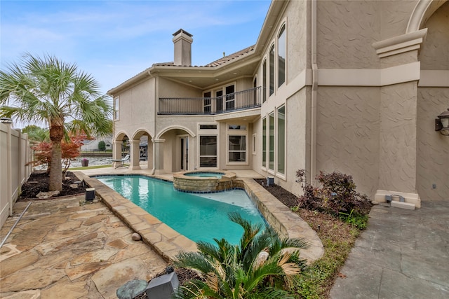 view of pool with a patio area and an in ground hot tub