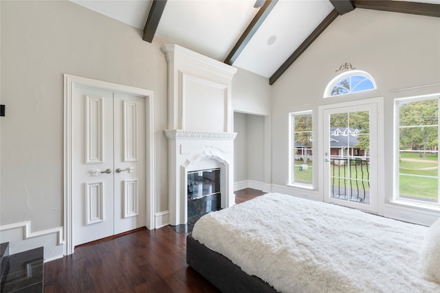 bedroom featuring dark wood-type flooring, a closet, high vaulted ceiling, and beam ceiling