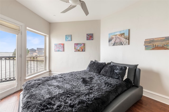 bedroom with access to exterior, dark hardwood / wood-style flooring, and ceiling fan