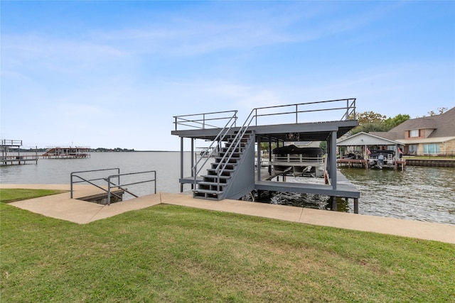 dock area with a water view and a yard