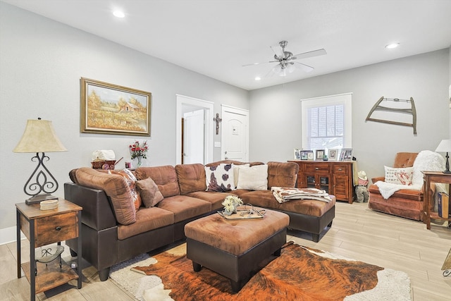 living room featuring light hardwood / wood-style flooring and ceiling fan