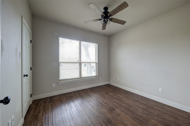 spare room featuring dark hardwood / wood-style floors and ceiling fan