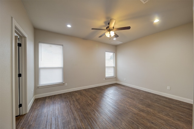 empty room with dark wood-type flooring and ceiling fan