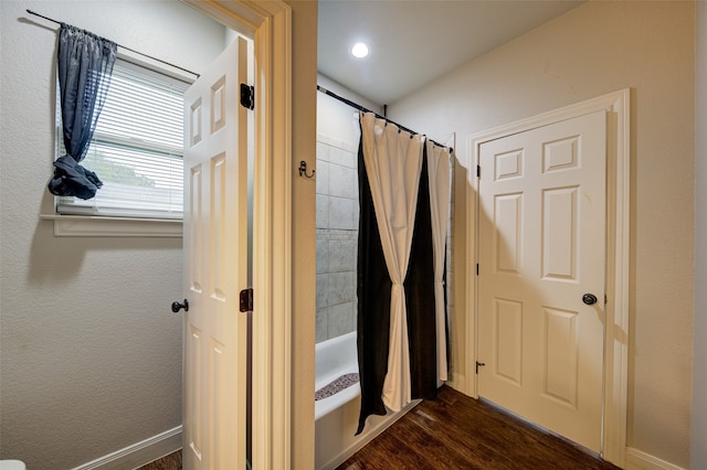 bathroom featuring shower / bath combo and hardwood / wood-style flooring