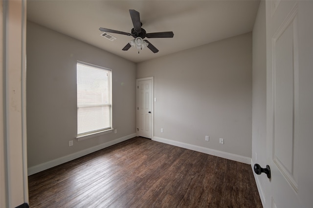 unfurnished room featuring ceiling fan and dark hardwood / wood-style flooring