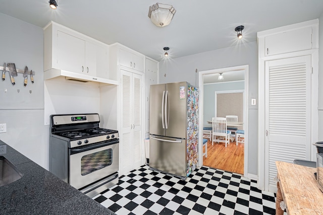 kitchen with white cabinetry, extractor fan, light hardwood / wood-style flooring, and appliances with stainless steel finishes