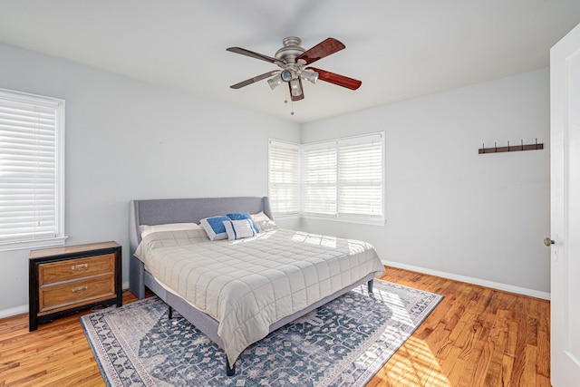 bedroom with hardwood / wood-style flooring and ceiling fan