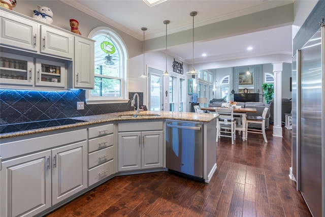 kitchen featuring crown molding, white cabinetry, appliances with stainless steel finishes, dark hardwood / wood-style floors, and sink