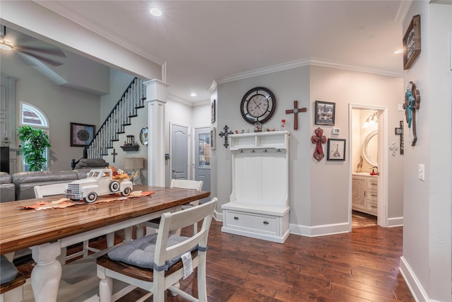 dining space featuring dark wood-type flooring, ceiling fan, ornamental molding, and decorative columns