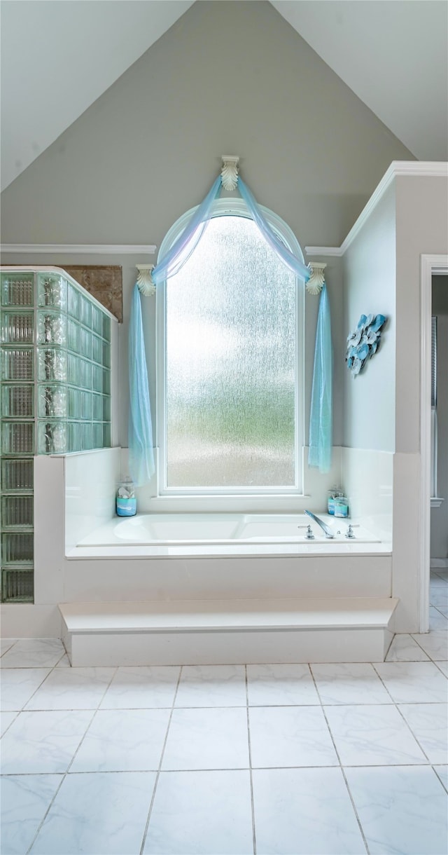 bathroom featuring lofted ceiling, tile patterned floors, and a tub