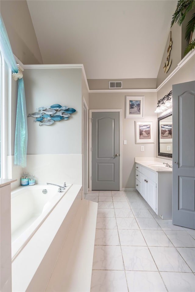 bathroom featuring vanity, lofted ceiling, and a bathing tub