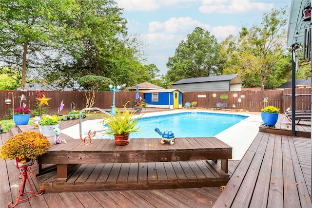 view of swimming pool with a deck and an outdoor structure