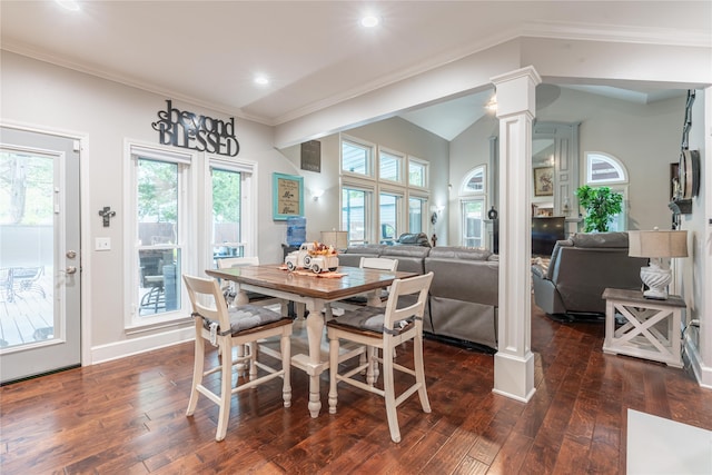 dining area with dark hardwood / wood-style floors, a healthy amount of sunlight, ornate columns, and crown molding