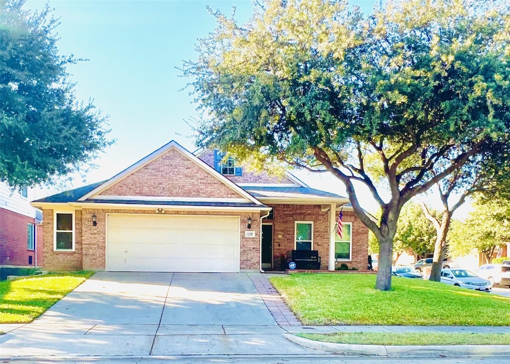 view of front of property with a garage and a front yard