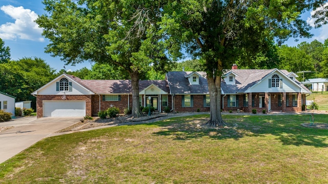 view of front of property with a garage and a front lawn