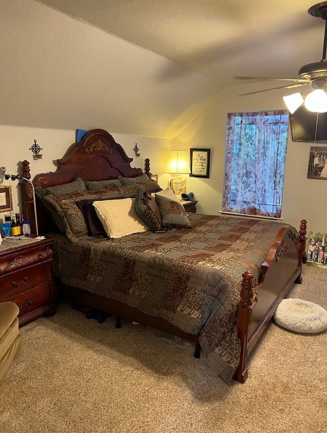 bedroom with a textured ceiling, carpet floors, ceiling fan, and vaulted ceiling