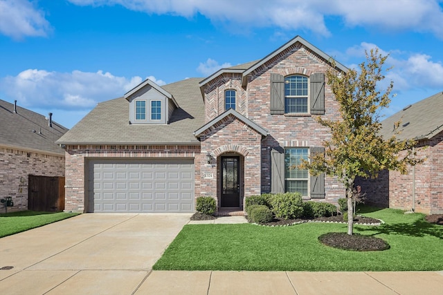 view of front of house with a garage and a front yard