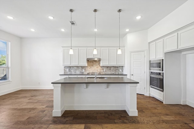 kitchen with white cabinetry, dark wood-type flooring, hanging light fixtures, and appliances with stainless steel finishes