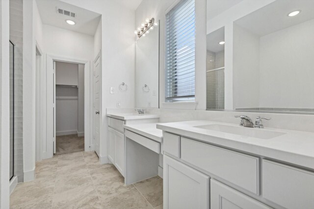 bathroom featuring tile patterned floors, vanity, and walk in shower