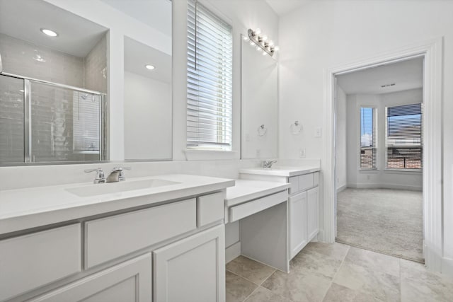 bathroom featuring vanity and an enclosed shower