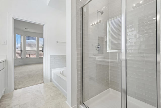 bathroom with plus walk in shower, vanity, and tile patterned floors