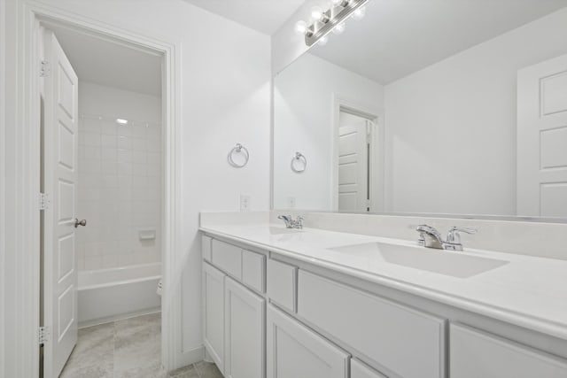 bathroom featuring vanity and tiled shower / bath combo